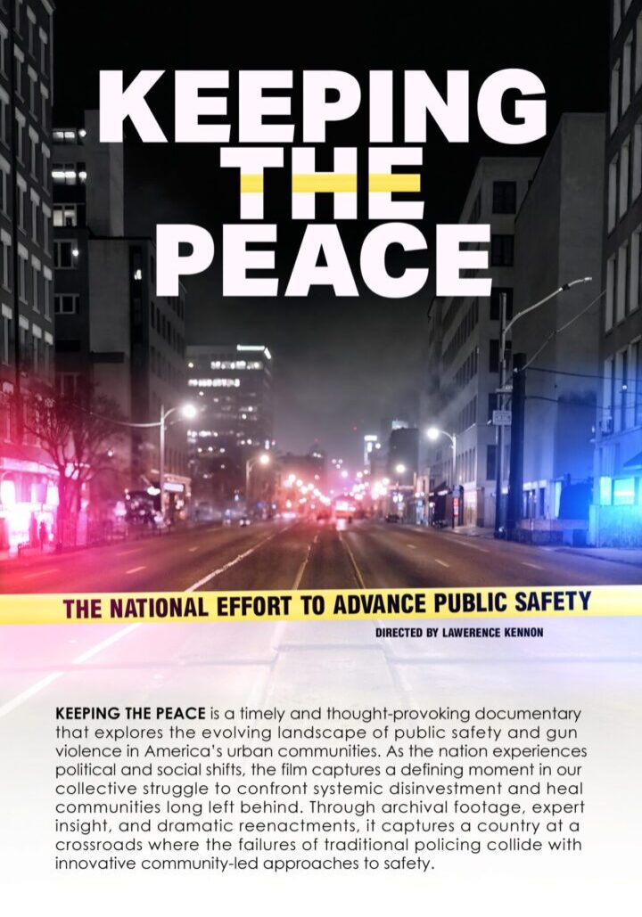 A city street at night with bright lights and a banner promoting peace and public safety.